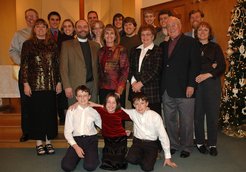 the 19 people in the church, next to a Christmas tree